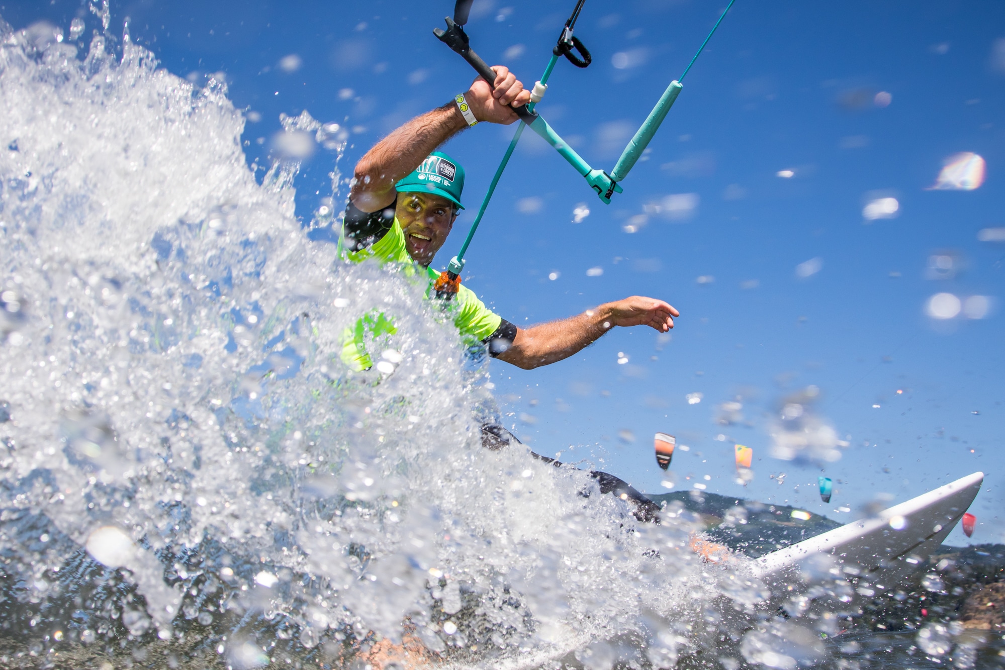 A kiteboarding splashing the camera